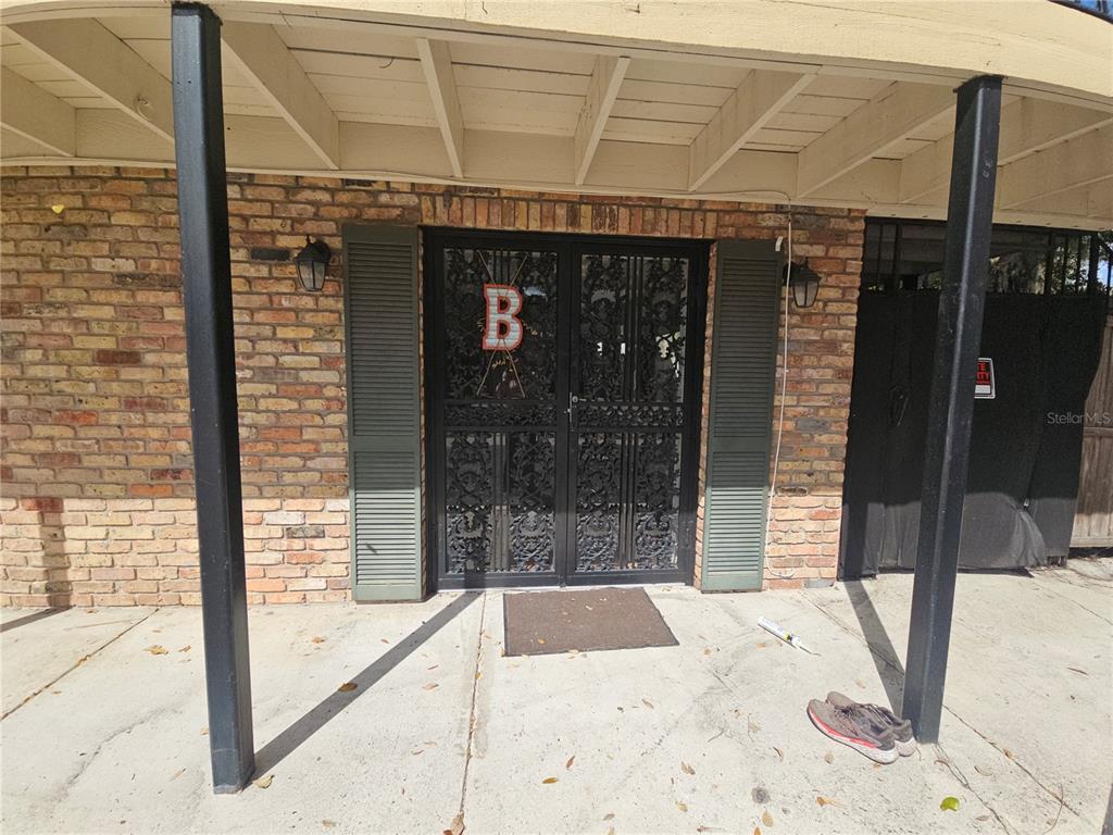 A brick exterior features a double security door with a letter B under a porch — 529 N FERN CREEK AVENUE, ORLANDO, FL