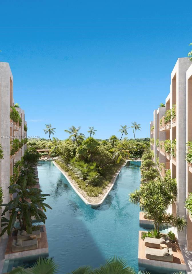 This architectural rendering shows a V-shaped swimming pool surrounded by lush landscaping and modern buildings — JJR6+692, Punta cana # 1, FL