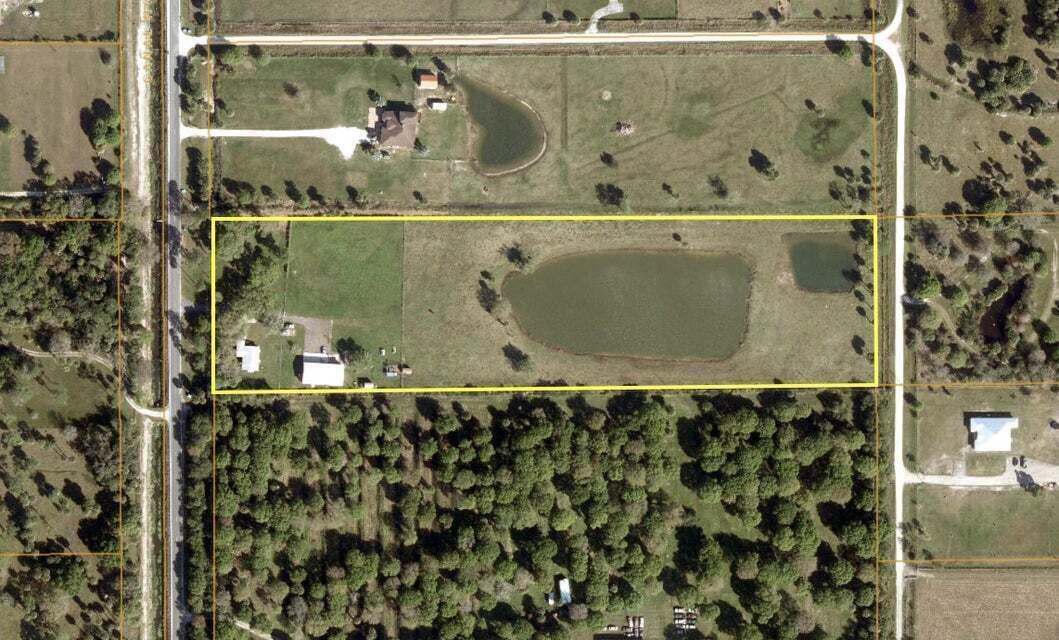 An aerial view shows a rectangular property featuring a house, outbuildings, and two ponds — 2410 S Brocksmith Road, Fort Pierce FL 34945, FORT PIERCE, FL