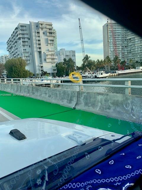 A view from a vehicle looking toward high-rise buildings and boats docked in a waterway — 150 SE 25th Rd Slip # 7, Miami FL 33129, MIAMI, FL