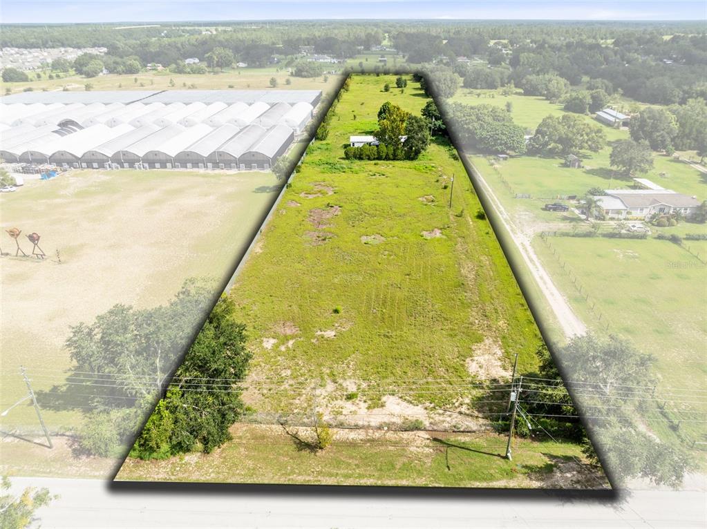 An aerial view shows a long, narrow rectangular lot featuring a small house and trees — 2719 W KELLY PARK ROAD, APOPKA, FL