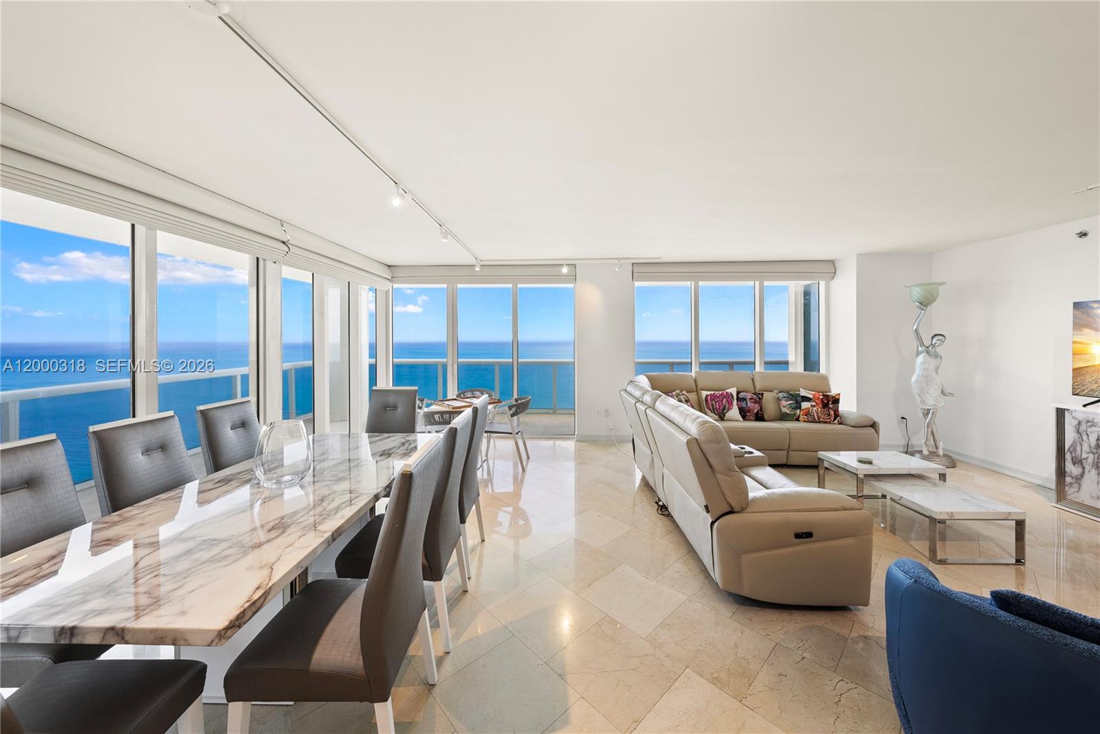 A bright open-concept living and dining area features marble floors, modern furniture, and ocean views — 1850 S Ocean Dr # 3301, Hallandale Beach FL 33009, HALLANDALE BEACH, FL