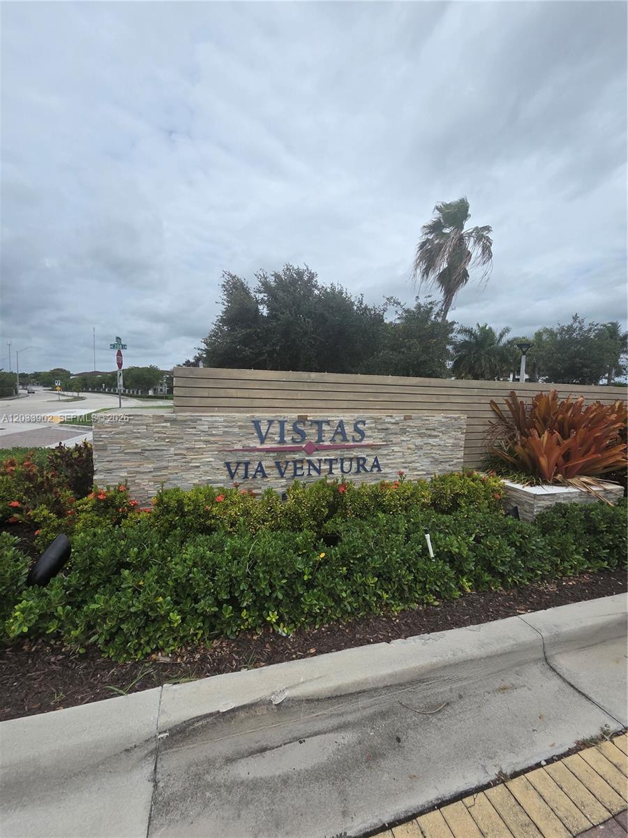 A stone monument sign for Vistas Via Ventura stands behind a landscaped garden bed — 21124 NE 8th Ave, Miami FL 33179, MIAMI, FL