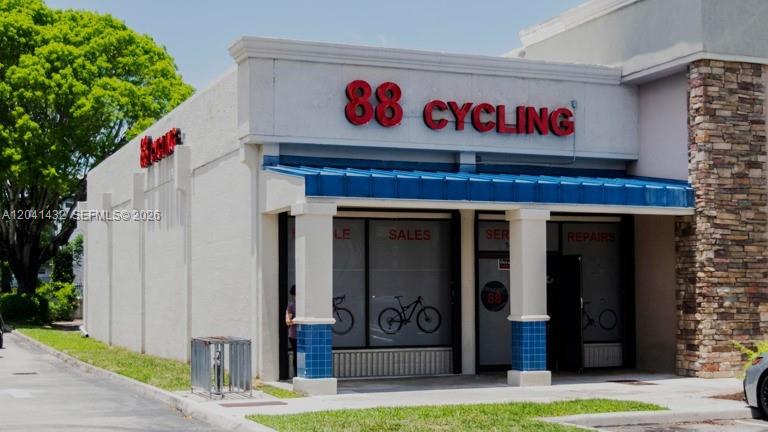 A single-story commercial building with a blue awning and the sign 88 Cycling — 14097 SW 88th St, Miami FL 33186, MIAMI, FL