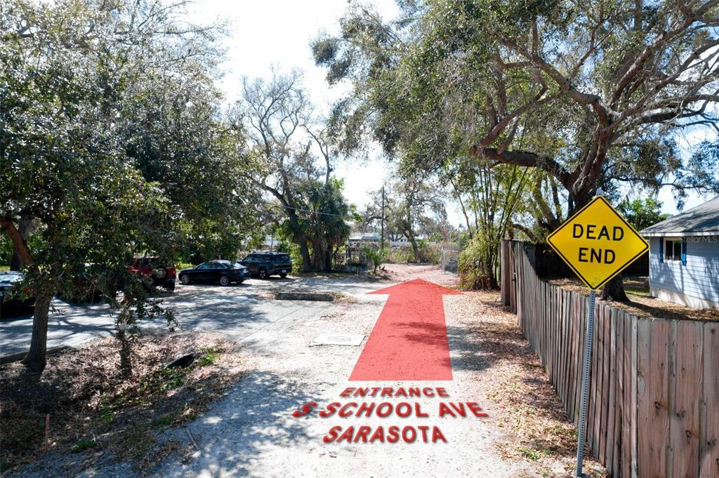 A dirt path leads toward a dead end sign next to a wooden fence — 4101 S SCHOOL AVENUE, SARASOTA, FL