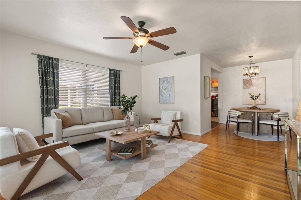 A living room with a sofa, two armchairs, a coffee table, and an adjacent dining area — 821 E CHURCH STREET, ORLANDO, FL