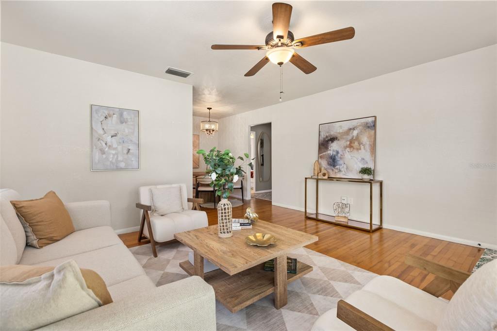 A living room features a light-colored sofa, two armchairs, a wooden coffee table, and hardwood floors — 821 E CHURCH STREET, ORLANDO, FL