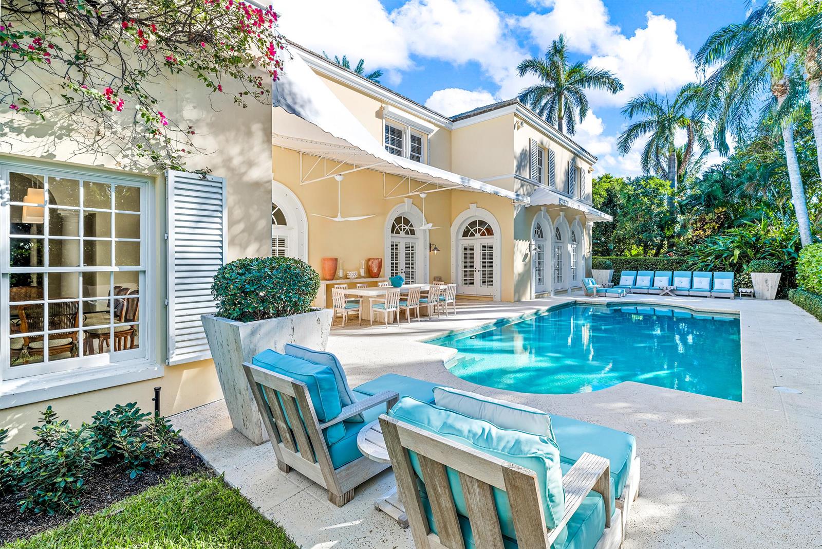 A backyard patio features a swimming pool, outdoor dining area, and lounge chairs by a house — 510 N Lake Way, Palm Beach FL 33480, PALM BEACH, FL
