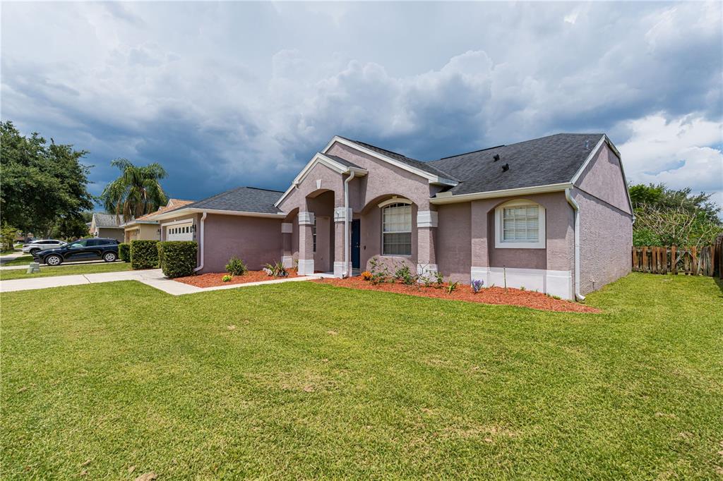 A single-story house with a stucco exterior, dark shingled roof, and a front lawn — 1837 FLORENCE VISTA BOULEVARD, ORLANDO, FL