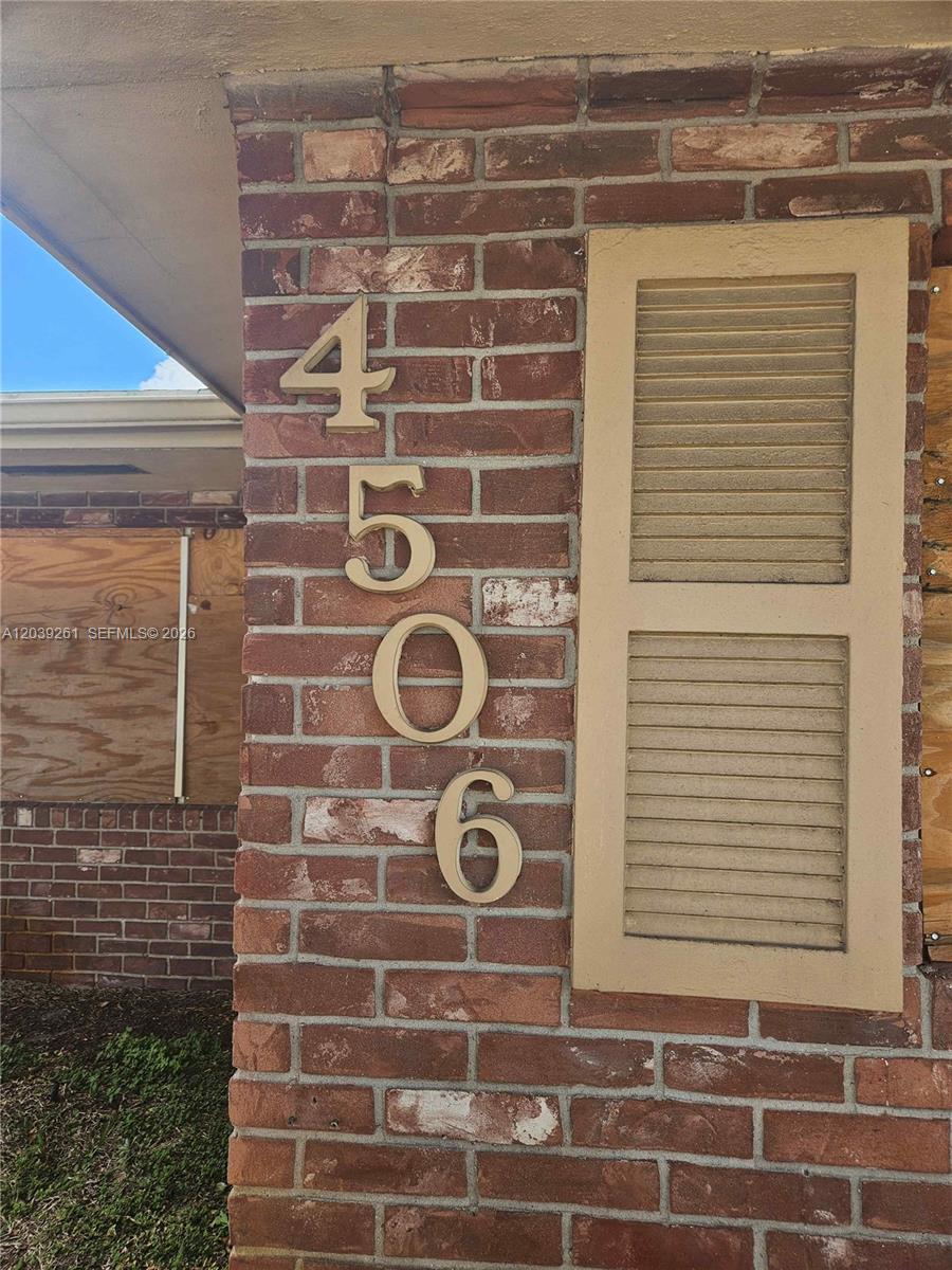 The house number 4506 is mounted on a red brick exterior wall with a shutter — 4506 Taft St, Hollywood FL 33021, HOLLYWOOD, FL