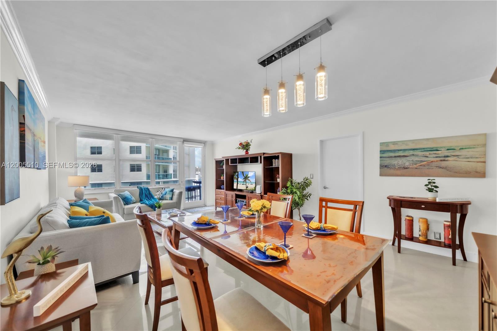 A dining area and living room with white walls, tile floors, and a wooden table — 3725 S Ocean Dr # 1220, Hollywood FL 33019, HOLLYWOOD, FL