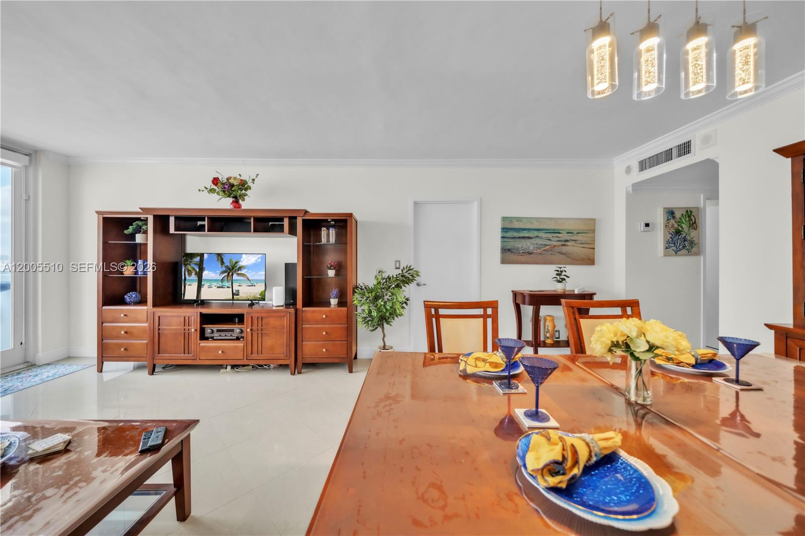 A dining area and living room feature a wooden entertainment center and dining table — 3725 S Ocean Dr # 1220, Hollywood FL 33019, HOLLYWOOD, FL