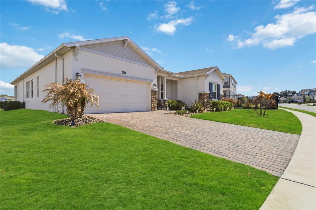 A single-story house with a paved driveway, a two-car garage, and a manicured lawn — 4409 EASTMINSTER ROAD, DAVENPORT, FL