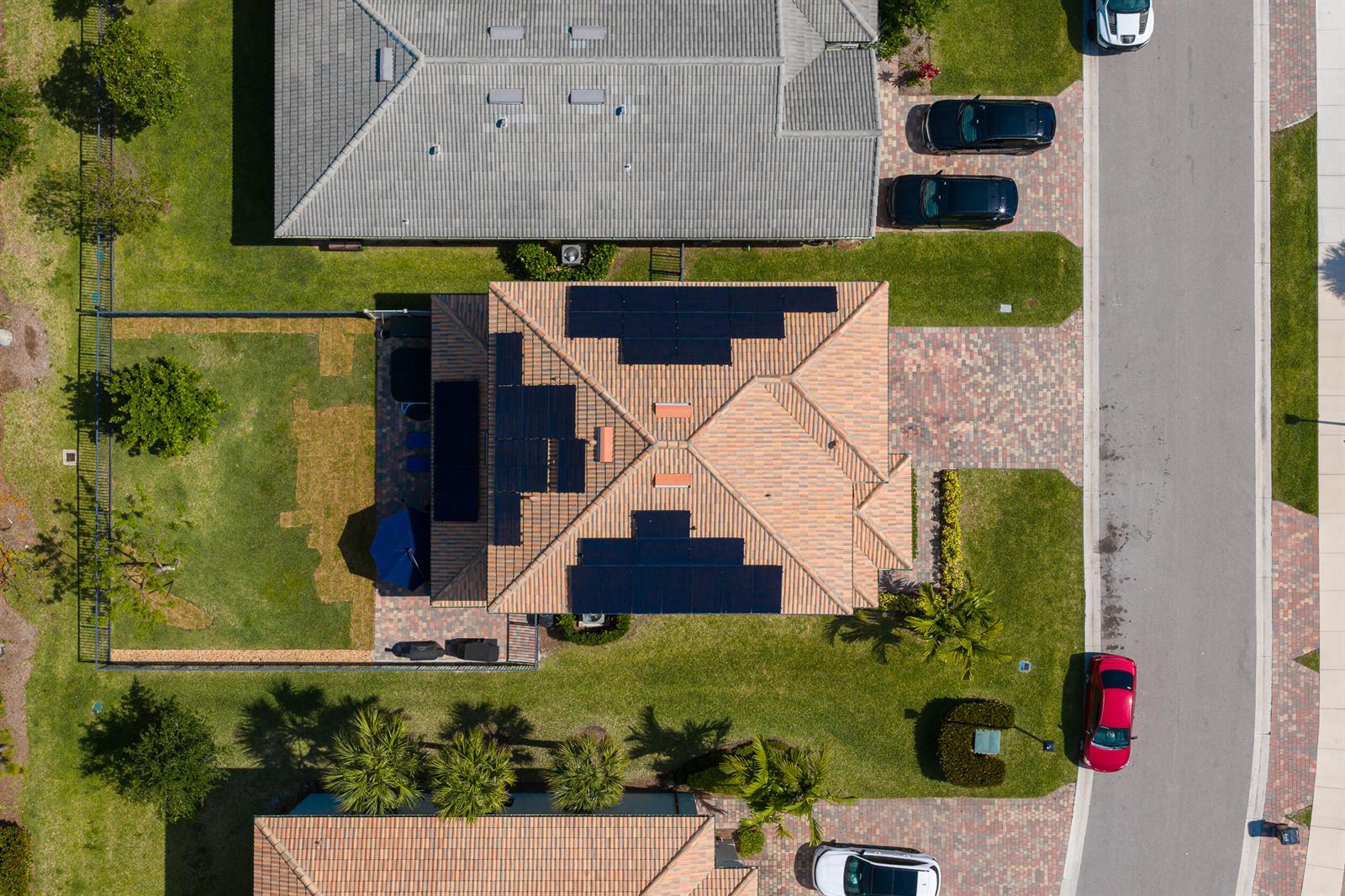An aerial view shows a house with solar panels on its roof and a backyard — 4819 Chantilly Road, Lake Worth FL 33467, LAKE WORTH, FL