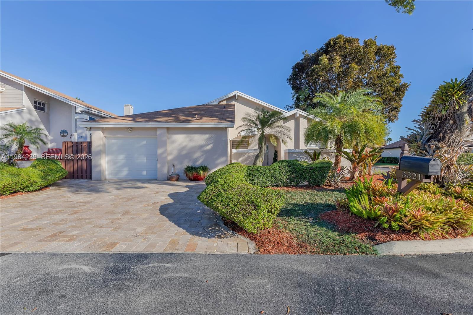 A single-story house features a paved driveway, a one-car garage, and landscaped front yard — 5321 SW 153rd Pl S, Miami FL 33185, MIAMI, FL