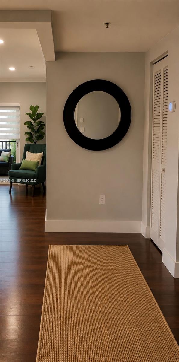 A hallway features a round black mirror on a gray wall above a jute rug — PEMBROKE PINES, FL