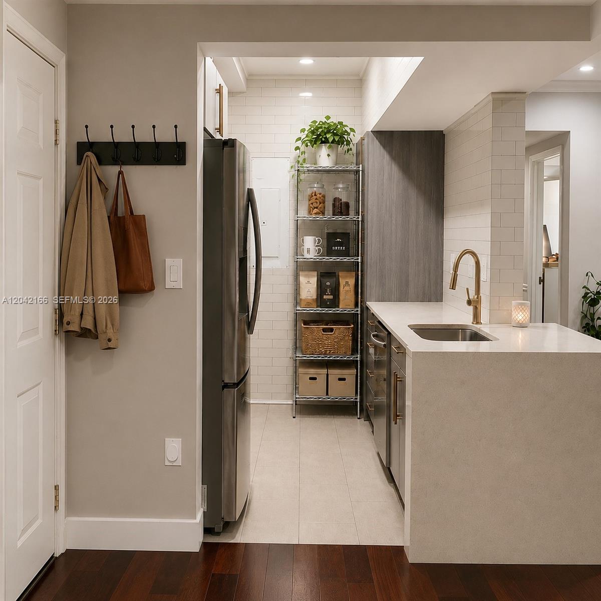 A modern kitchen features stainless steel appliances, white subway tile, and a quartz countertop — PEMBROKE PINES, FL