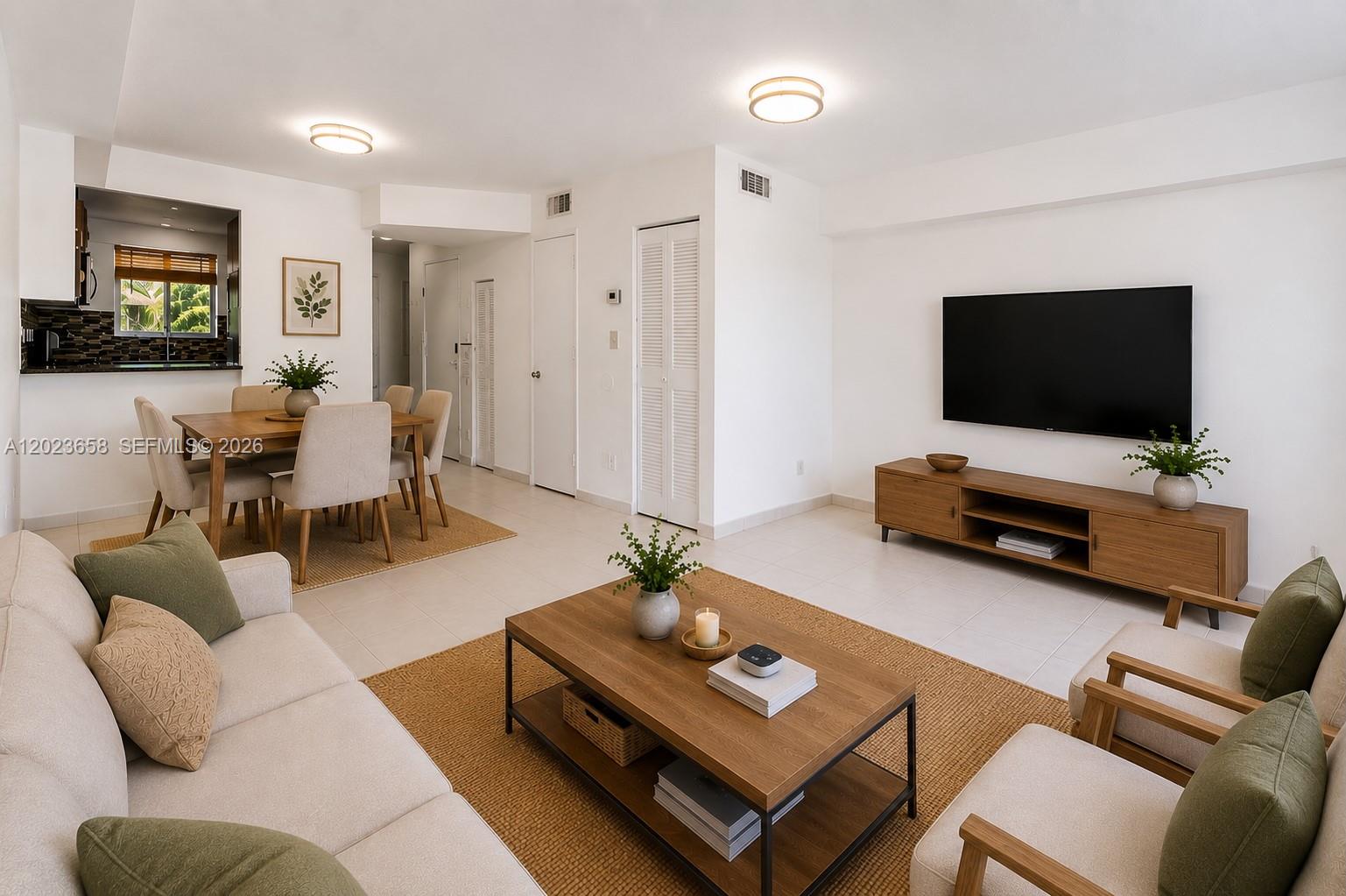 A bright living and dining area features white walls, tile floors, and wood furniture — 3021 W 76th St # 203, Hialeah FL 33018, HIALEAH, FL