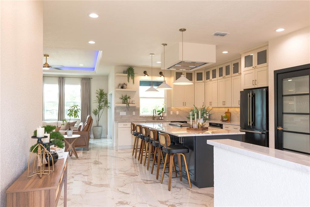 A modern home exterior features a dark blue stucco facade, wood accents, and a front porch — 6254 W PEKING COURT, DUNNELLON, FL
