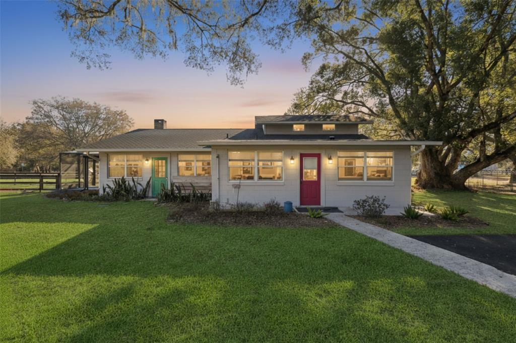 A single-story house with a red front door, a green side door, and large windows — 43411 STATE ROAD 19, ALTOONA, FL