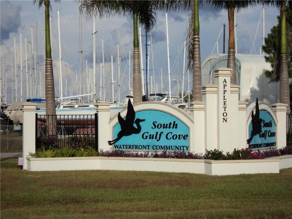 A sign for South Gulf Cove Waterfront Community stands in front of a boat marina — 10441 VAN WYCK TERRACE, PORT CHARLOTTE, FL