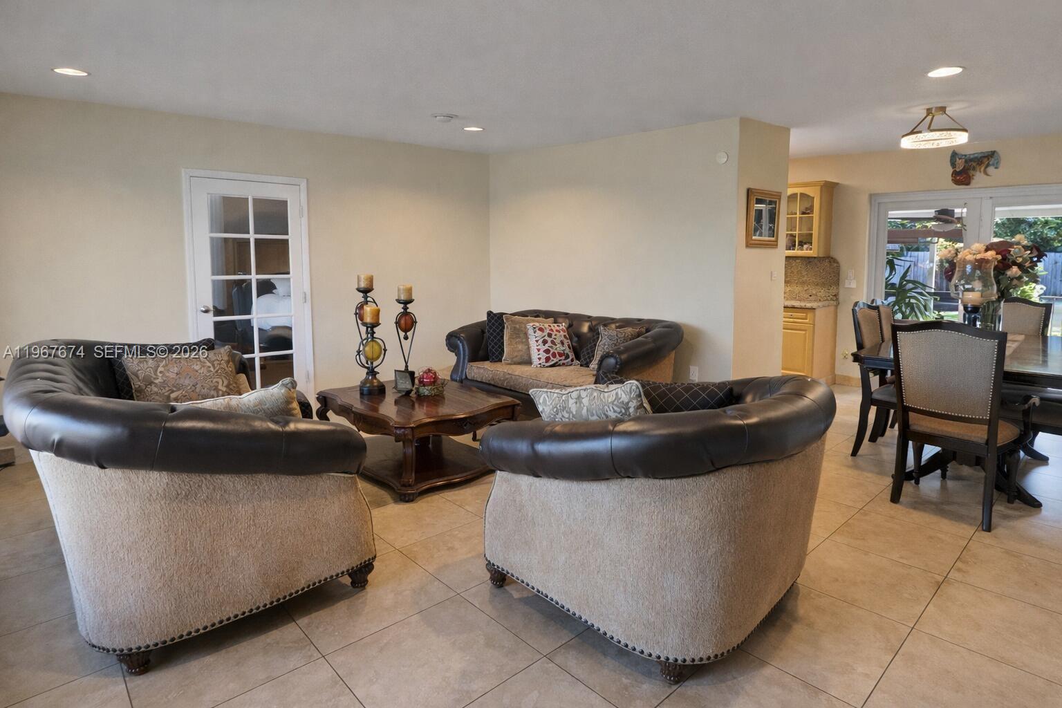 A living room features two leather-trimmed armchairs, a sofa, and a dining area nearby — 1901 SW 90th Ave, Miami FL 33165, MIAMI, FL