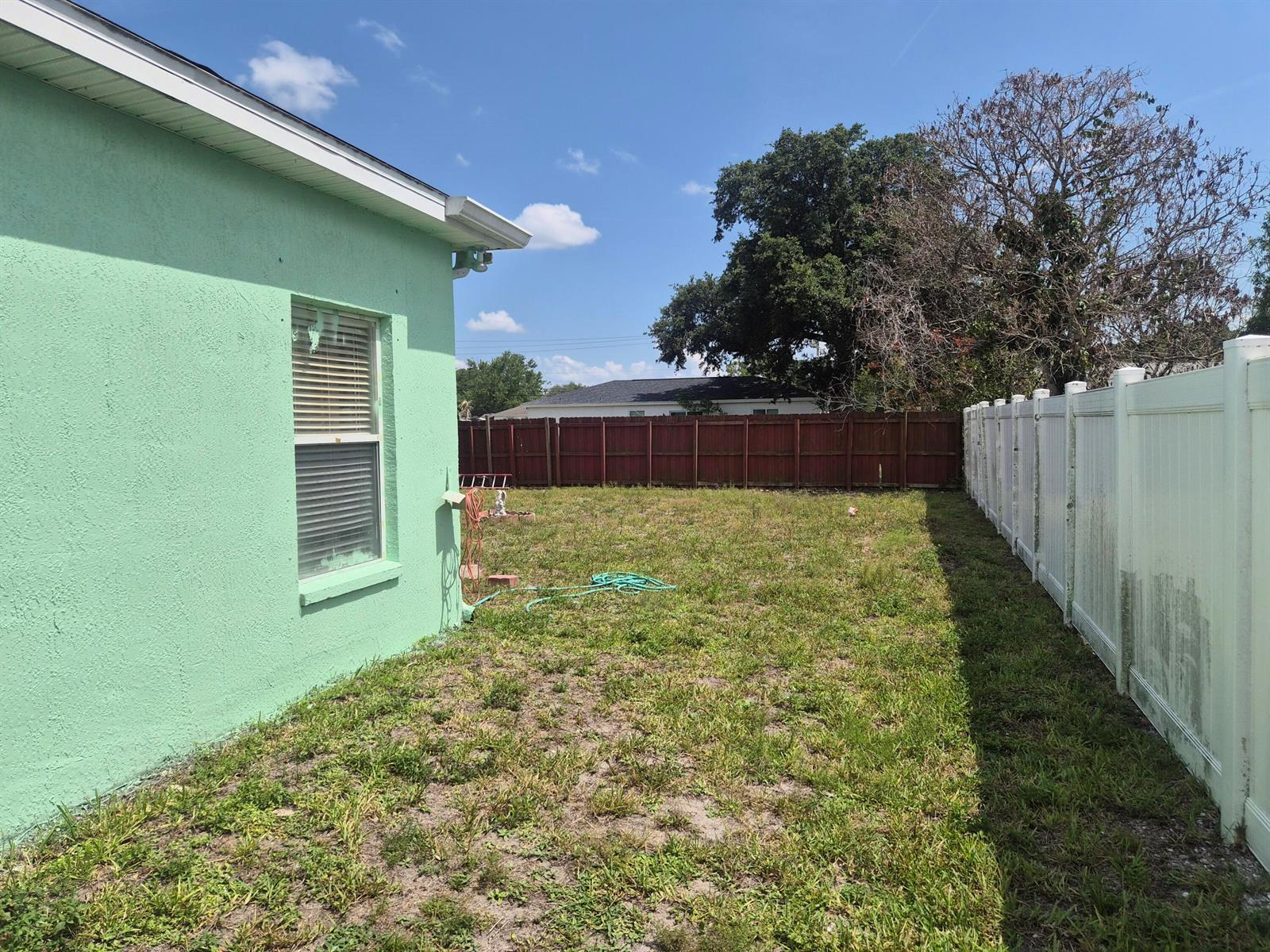 A kitchen features wood cabinets, stainless steel appliances, and tan countertops — 698 Thuringer Street NW, Palm Bay FL 32907, PALM BAY, FL