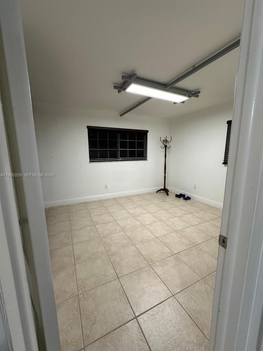 A room with light-colored tile flooring, white walls, and a rectangular ceiling light fixture — 8500 SW 109th Ave # 202, Miami FL 33173, MIAMI, FL