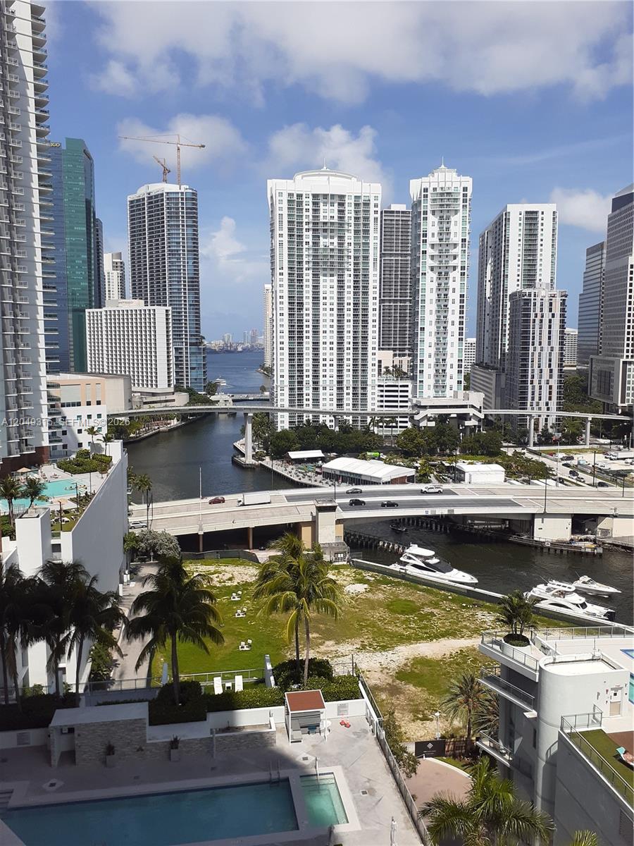 An elevated view of a Miami canal, bridges, high-rise buildings, and a swimming pool — 90 SW 3rd St # 1914, Miami FL 33130, MIAMI, FL