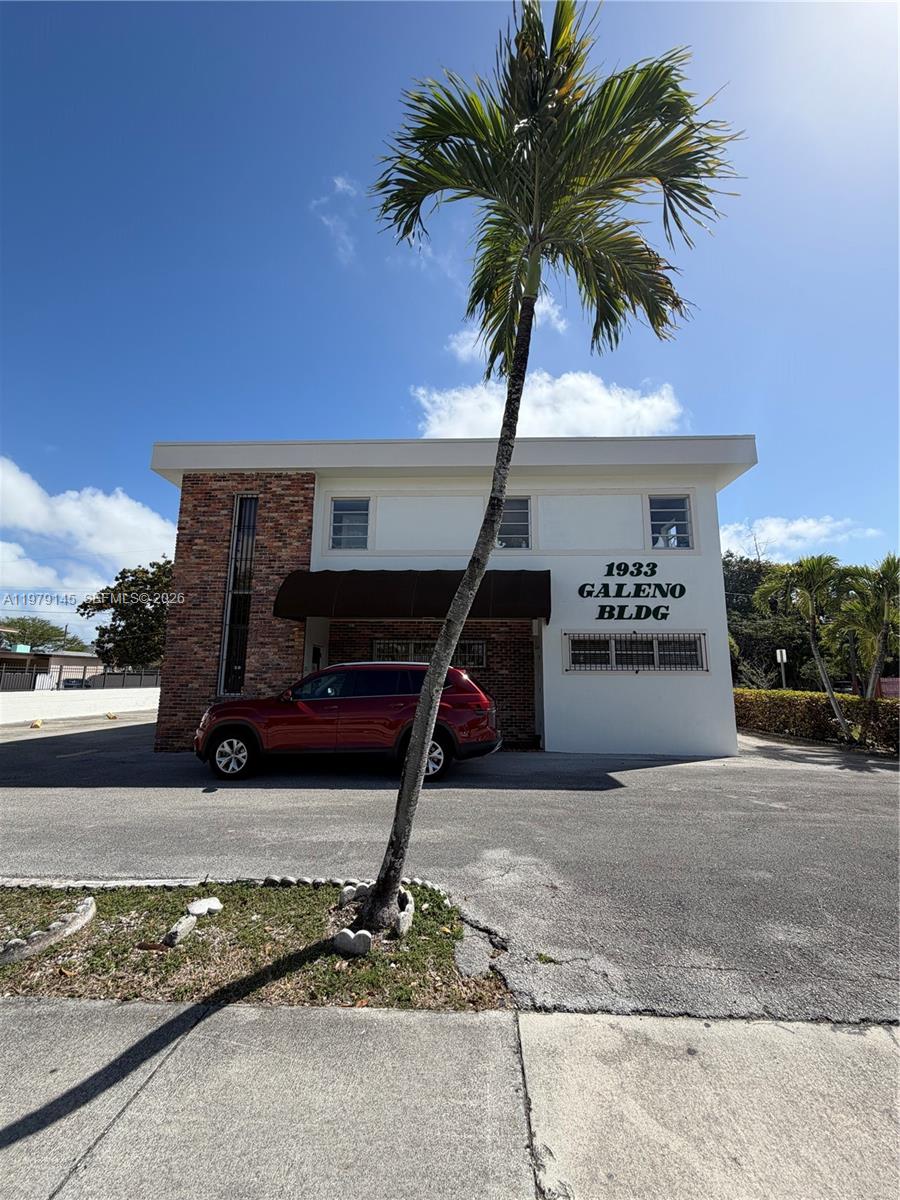A two-story building with a brick facade and a palm tree in the foreground — 1933 SW 27th Ave, Miami FL 33145, MIAMI, FL