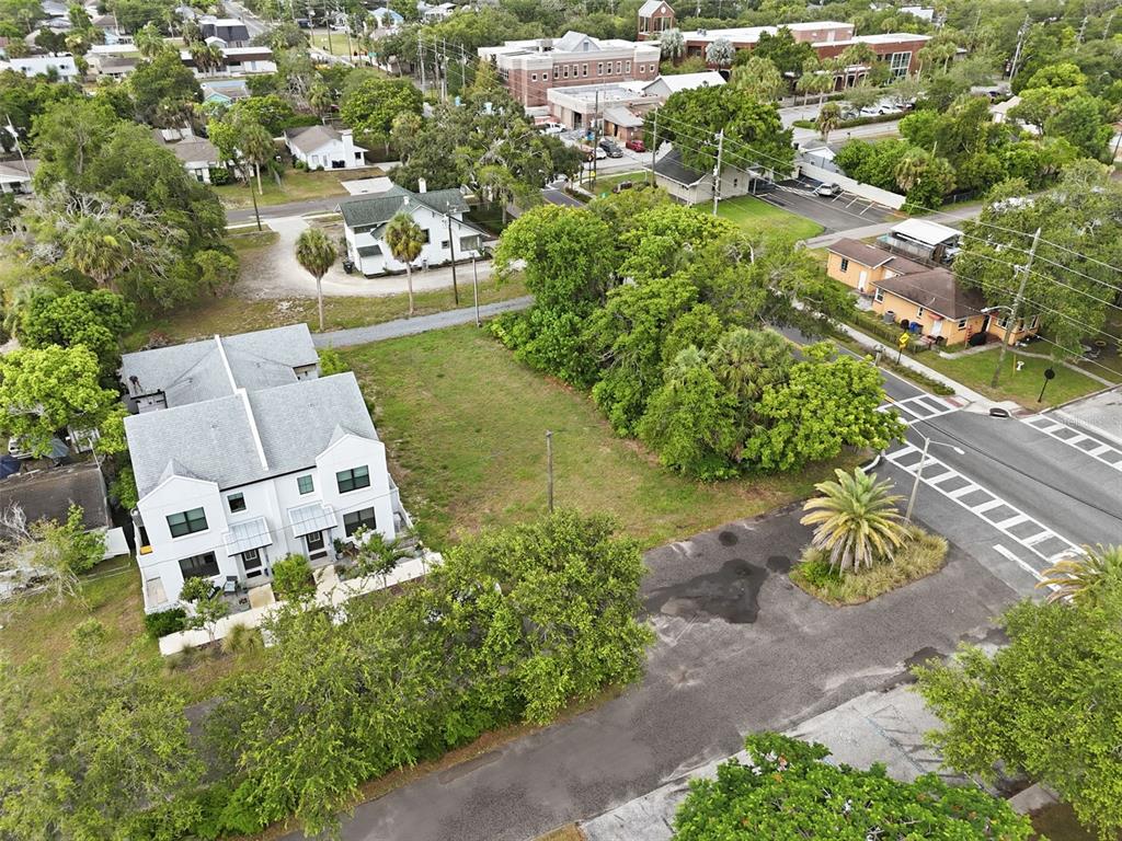 An aerial view shows a vacant lot situated between a modern duplex and a street — 5972 CENTRAL AVENUE, NEW PORT RICHEY, FL