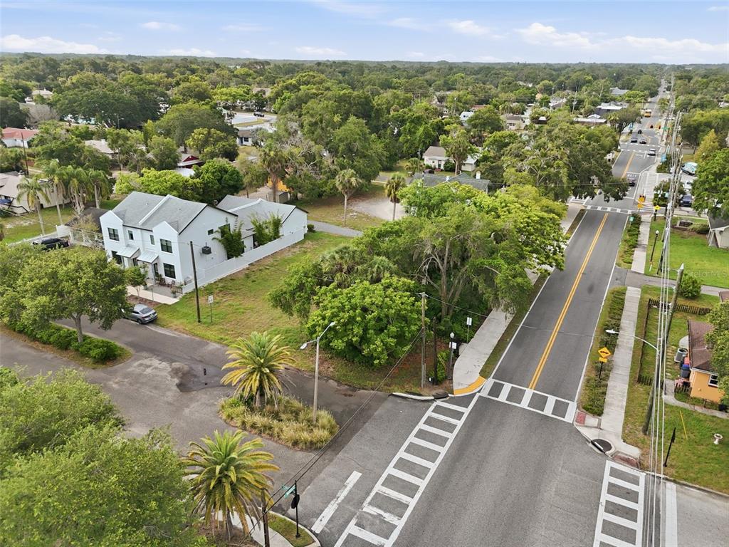 An aerial view shows a two-story house, a street intersection, and surrounding trees — 5972 CENTRAL AVENUE, NEW PORT RICHEY, FL