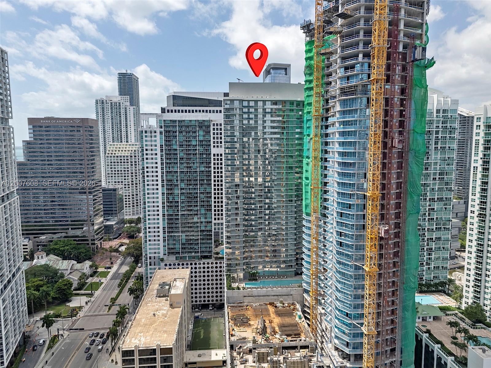 An aerial view shows a dense urban skyline with high-rise buildings and a construction site — 77 SE 5th St. # 1510, Miami FL 33131, MIAMI, FL