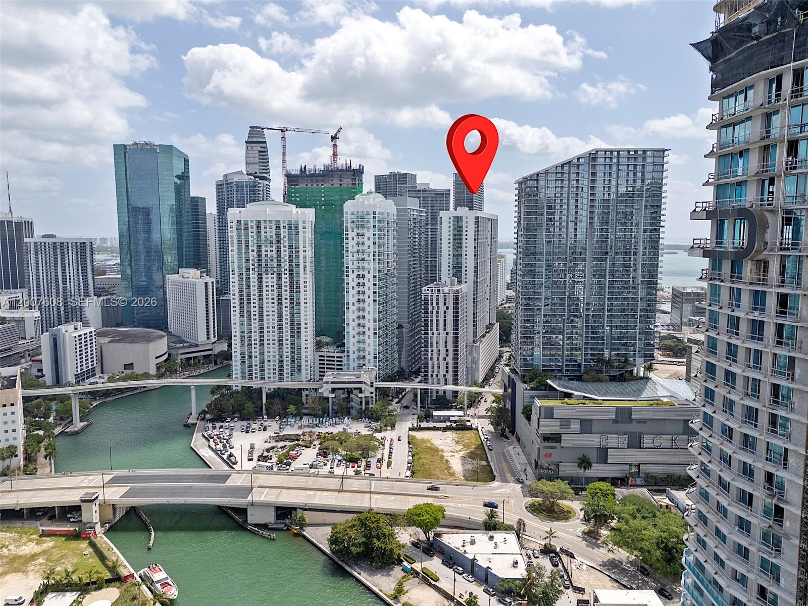 An aerial view of the Miami skyline featuring high-rise buildings, a canal, and bridges — 77 SE 5th St. # 1510, Miami FL 33131, MIAMI, FL
