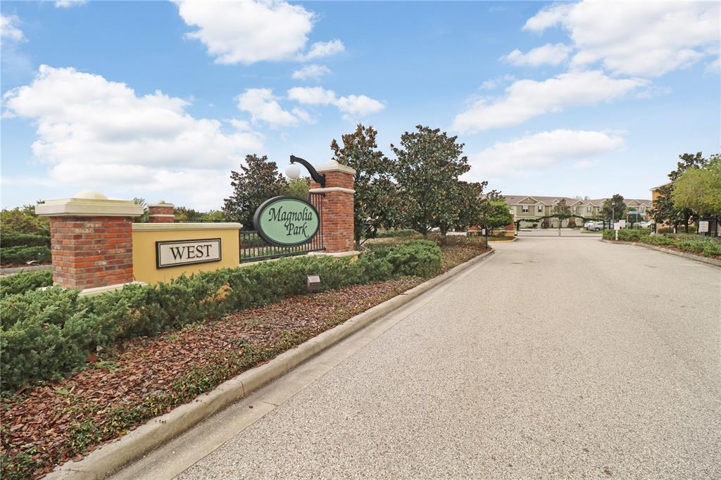 A brick entrance sign for Magnolia Park West stands beside a paved residential road — 4605 SOMERSET HILL LANE, RIVERVIEW, FL