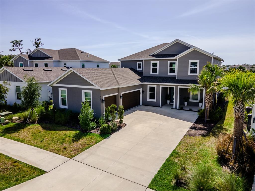 An aerial view of a two-story gray house with a driveway and attached garage — 9121 RADIANT CIRCLE, SARASOTA, FL