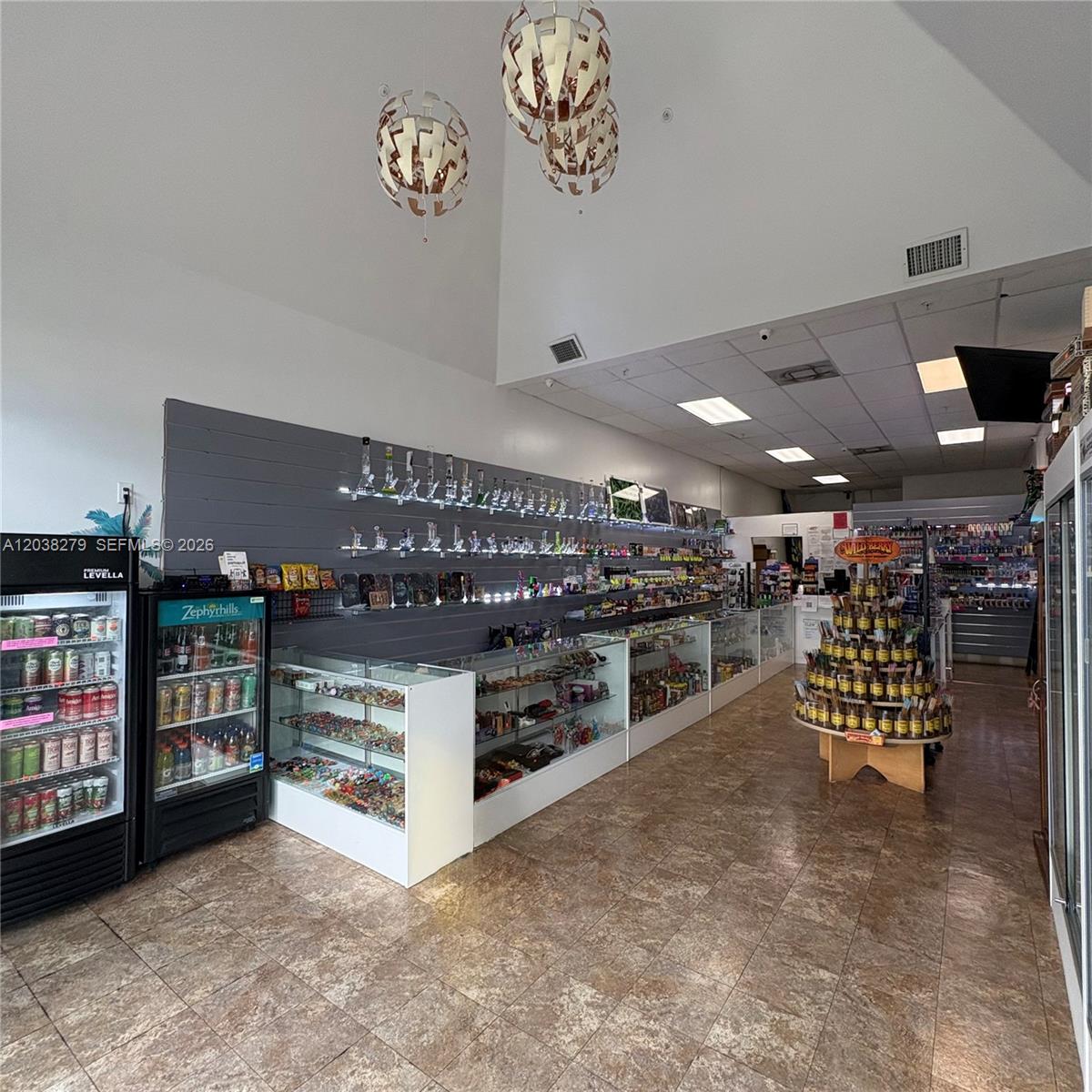 This retail store features glass display cases, wall-mounted shelves, and a tiled floor — 5901 Johnson St, Hollywood FL 33021, HOLLYWOOD, FL