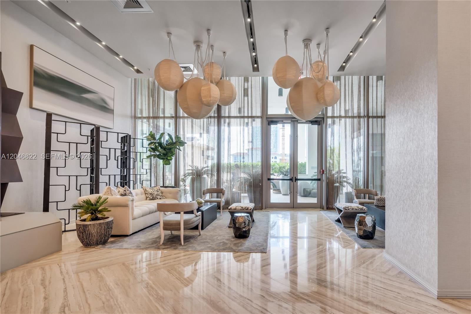 A low-angle view of the Biscayne Beach high-rise residential building with palm trees — 2900 NE 7th Ave # 4308, Miami FL 33137, MIAMI, FL
