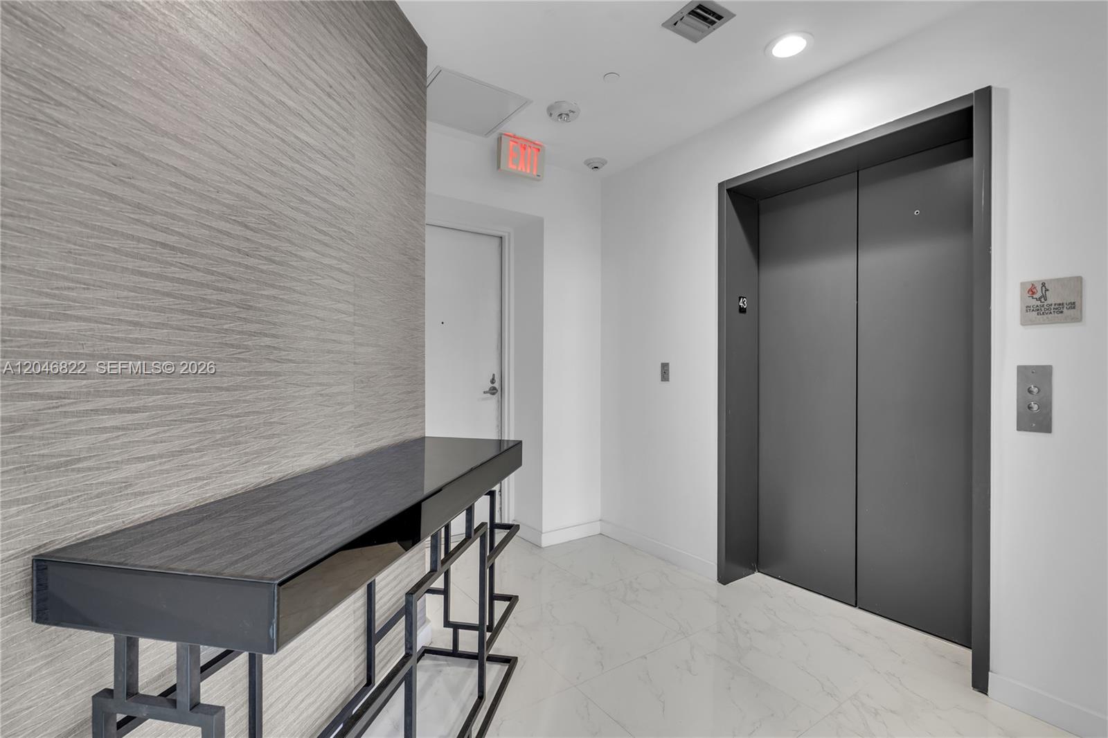A modern lobby features marble floors, large paper pendant lights, and floor-to-ceiling windows — 2900 NE 7th Ave # 4308, Miami FL 33137, MIAMI, FL