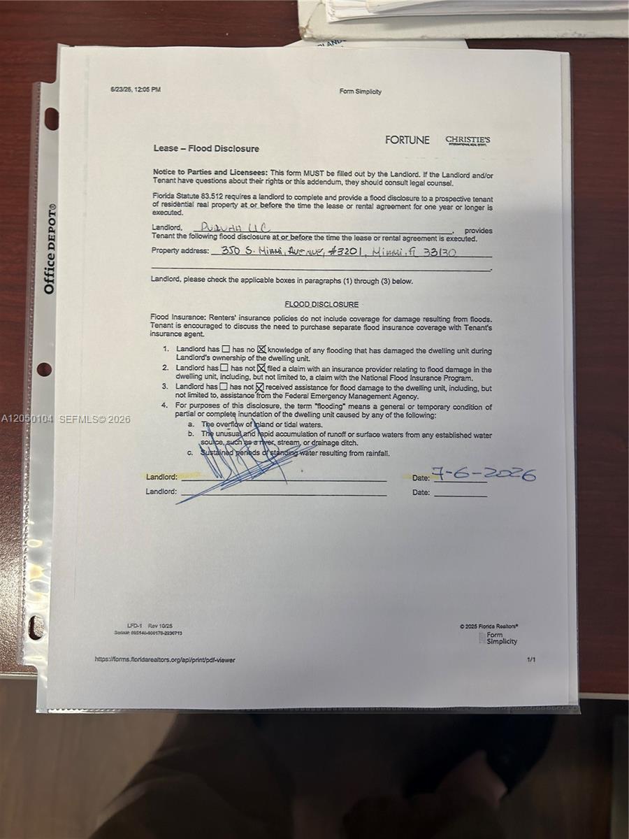 A document titled Lease - Flood Disclosure sits on a desk — 350 S Miami Ave # 3201, Miami FL 33130, MIAMI, FL