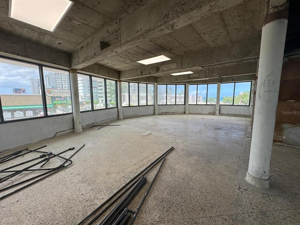 An unfinished commercial space features concrete ceilings, large windows, and a terrazzo floor — 1064 AV. ISLA VERDE, CAROLINA, PR