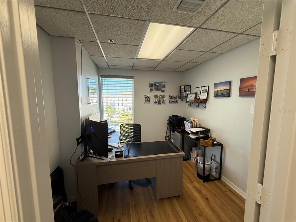 A small office features a desk, a window with blinds, and wood-look flooring — 1219 S EAST AVENUE UNIT 3-304, SARASOTA, FL