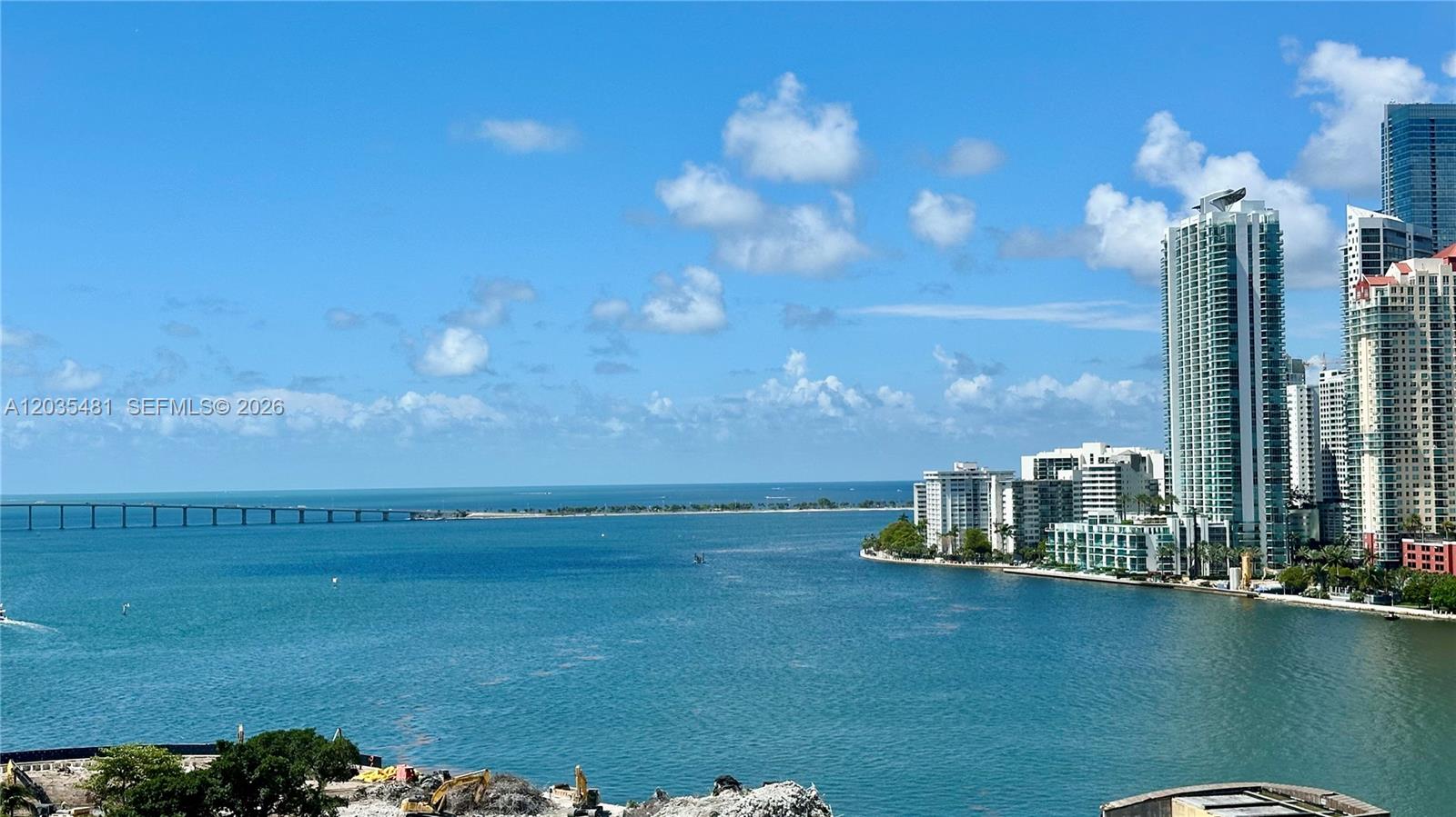 A high-angle view shows a bay with a bridge and coastal high-rise buildings — 520 SE Brickell Key Dr # A1615, Miami FL 33131, MIAMI, FL