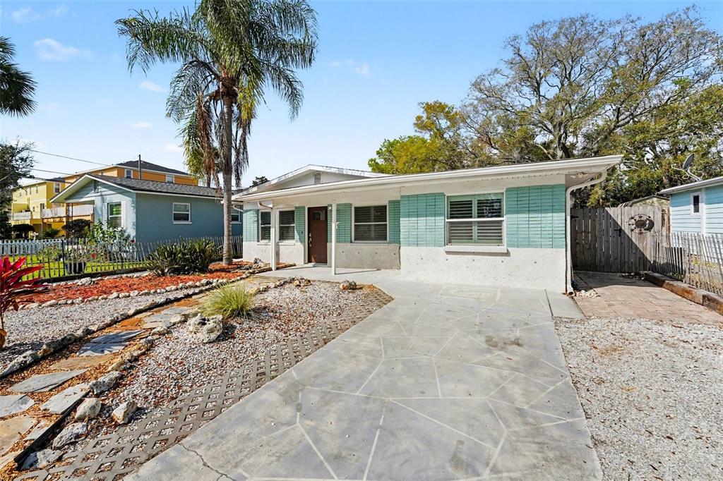 A single-story house with a light blue and white facade and a paved driveway — 318 BATH STREET, TARPON SPRINGS, FL