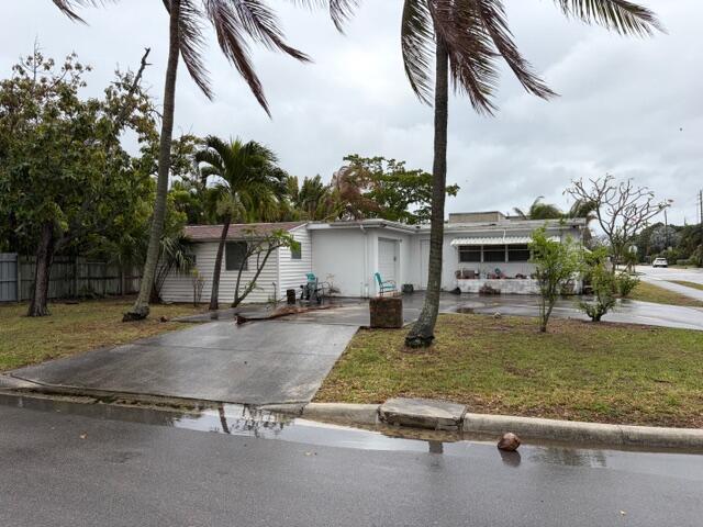 A single-story white house with a concrete driveway and palm trees in the front yard — 1029 Ardmore Road, West Palm Beach FL 33401, WEST PALM BEACH, FL