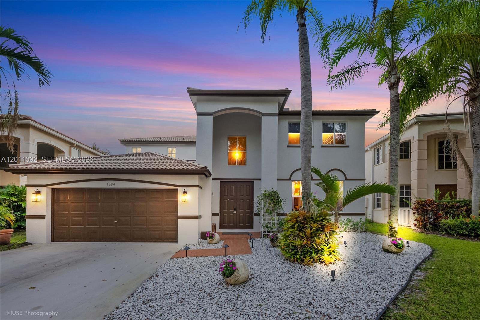 A two-story house with a brown garage door, arched entryway, and white gravel landscaping — 4394 Fox Ridge Dr, Weston FL 33331, WESTON, FL