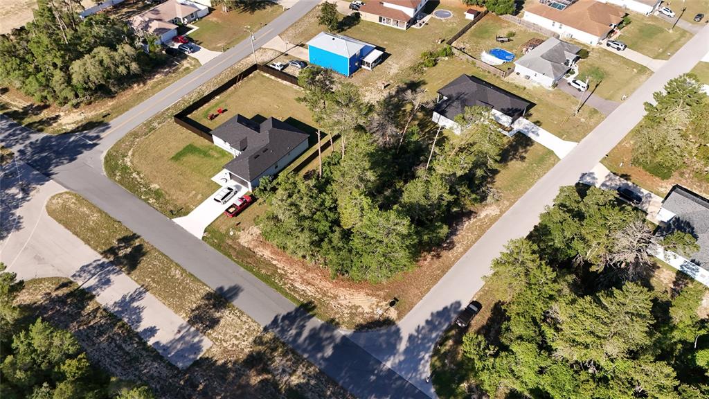 An aerial view shows a residential lot with trees, a house, and surrounding streets — TBD 127TH LANE ROAD, OCALA, FL