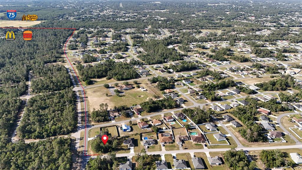 This aerial view shows a residential neighborhood with a red-outlined lot and a location pin — TBD 127TH LANE ROAD, OCALA, FL