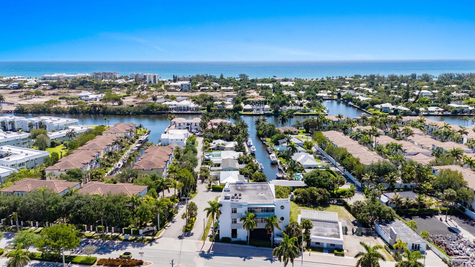An aerial view shows a multi-story building near a canal, surrounded by palm trees — 3330 N Federal Highway, Boynton Beach FL 33435, BOYNTON BEACH, FL