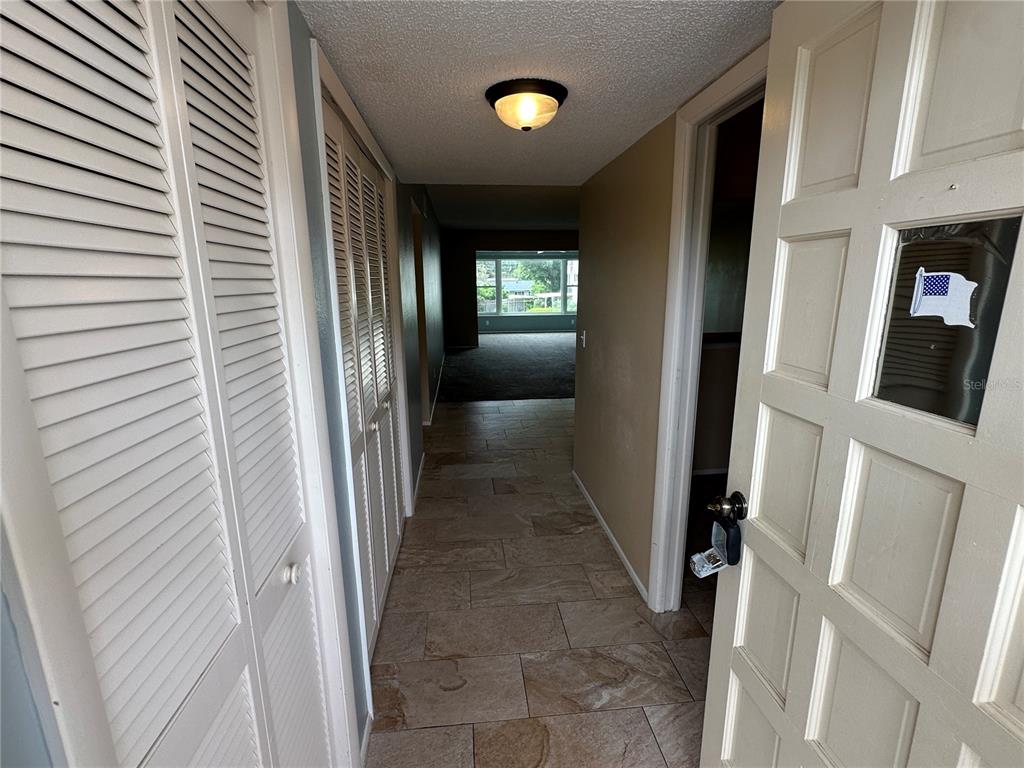 A tiled entryway leads to a carpeted living area through an open doorway — 2285 ISRAELI DRIVE UNIT 29, CLEARWATER, FL